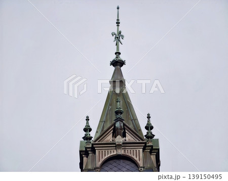 Gothic tower scene. Historical landmark silhouette with elaborate gothic metal accents under moody sky Gothic tower scene. Historical landmark silhouette with elaborate gothic metal accents under moody sky 139150495