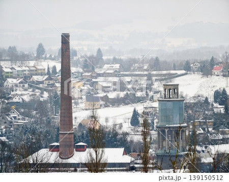 Snowy rooftops with distant hills. City skyline during winter with muted colors and quiet mood Snowy rooftops with distant hills. City skyline during winter with muted colors and quiet mood 139150512