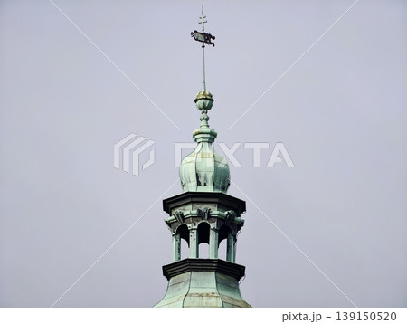 Decorative dome with weather vane. Heritagestyle rooftop element with spherical finial and weather vane Decorative dome with weather vane. Heritagestyle rooftop element with spherical finial and weather vane 139150520