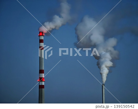 Factories emit pollution. Factory chimneys send dark smoke over open horizon during operation 139150542