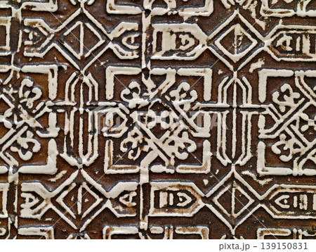 Historic ceramic tile featuring complex arabesque designs amidst weathered plaster and vibrant color contrasts Historic ceramic tile featuring complex arabesque designs amidst weathered plaster and vibrant color contrasts 139150831