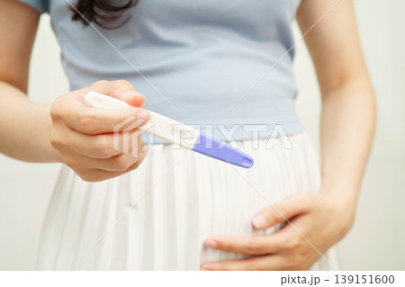 Asian holding pregnancy test for female of ovulation day, fetus, maternity, childbirth, birth control. 139151600