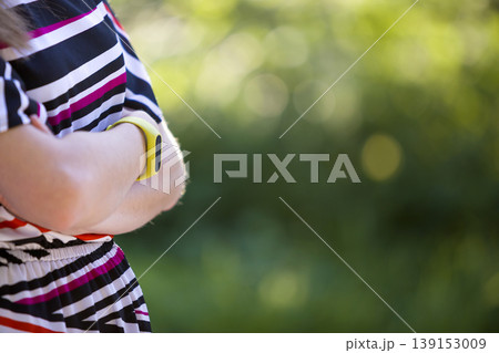 Young woman arms with fitness bracelet on outdoors blurred background. Young woman arms with fitness bracelet on outdoors blurred background. 139153009