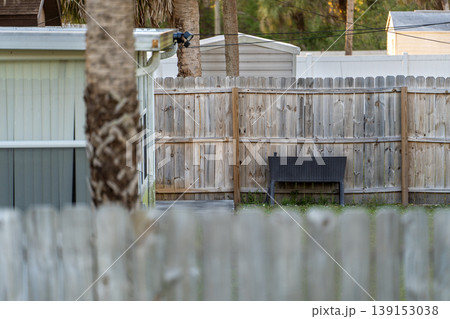 Wooden fence surrounding private property grounds for backyard protection and privacy in southern Florida 139153038