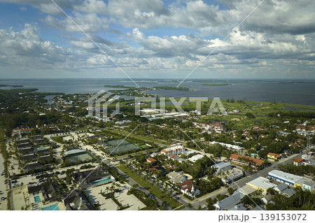 Wealthy neighborhood in small town Boca Grande, Florida with expensive waterfront houses between green palm trees. Development of US premium housing Wealthy neighborhood in small town Boca Grande, Florida with expensive waterfront houses between green palm trees. Development of US premium housing 139153072