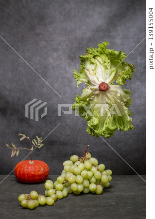 Still life with salad, pumpkin, and grapes 139155004
