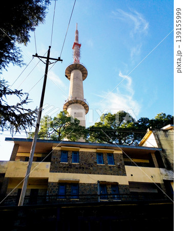 Tall Telecommunication Tower Above Residential Building Under Blue Sky 139155999