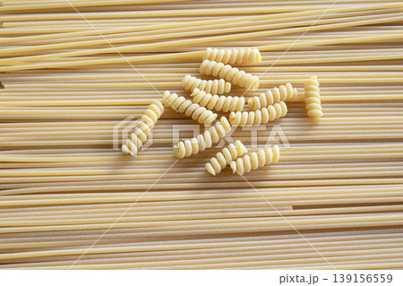 Fusilli and spaghetti dry pasta mix background texture Fusilli and spaghetti dry pasta mix background texture 139156559