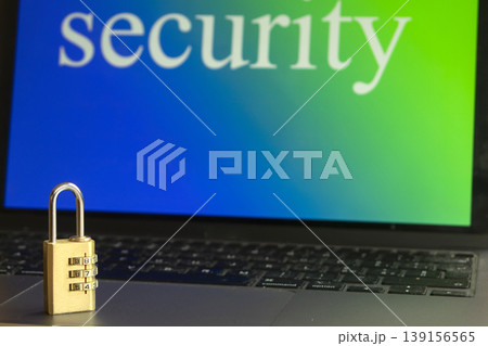 Combination padlock on laptop keyboard with security text on screen 139156565