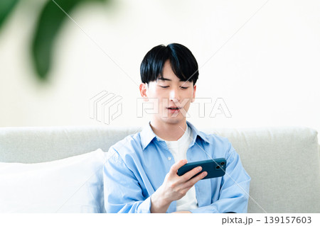 リビングでスマホを使う男性 リビングでスマホを使う男性 139157603