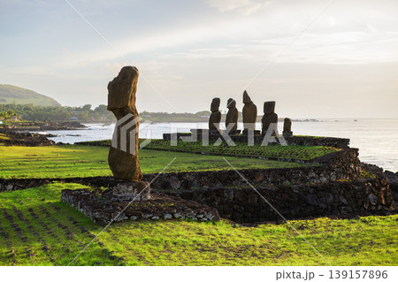 Majestic moai statue stands on serene easter island chile overlooking calm ocean landscape Majestic moai statue stands on serene easter island chile overlooking calm ocean landscape 139157896