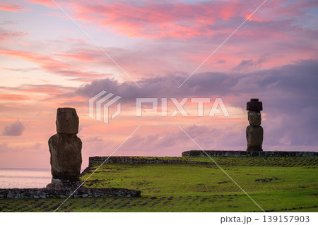 Peaceful moai statue stands on easter island chile under pink sunset sky 139157903