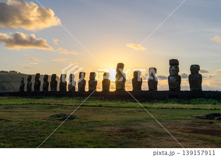 Stoic moai statue row silhouette during serene sunset on easter island chile Stoic moai statue row silhouette during serene sunset on easter island chile 139157911