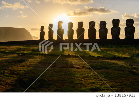 Peaceful silhouette of mysterious moai statue on easter island chile during golden sunset Peaceful silhouette of mysterious moai statue on easter island chile during golden sunset 139157913
