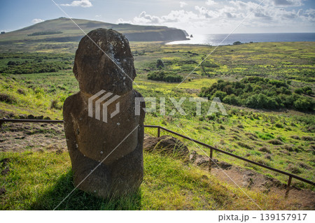 Stoic stone moai statue guarding grassy easter island coast in chile Stoic stone moai statue guarding grassy easter island coast in chile 139157917