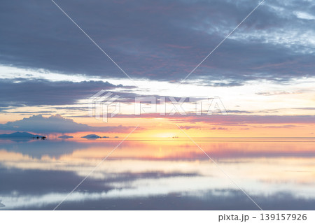 Serene sunset reflection on uyuni salt flat bolivia vast landscape Serene sunset reflection on uyuni salt flat bolivia vast landscape 139157926