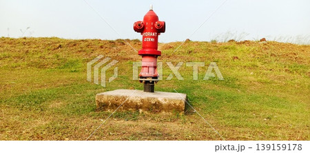 Fire extinguisher in open field Fire extinguisher in open field 139159178