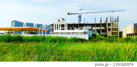 Urban development with construction site and gas station Urban development with construction site and gas station 139160974