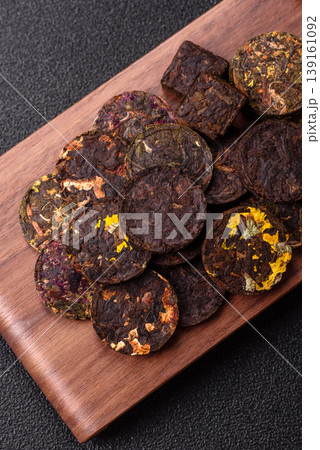 Organic Chinese green pu-erh tea with various herbs in round bricks. Chinese pu-erh tea 139161092