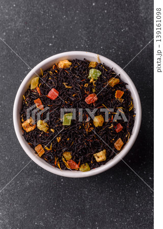Dry black tea with herbal leaves and aromatic additives. Dry fruity black tea 139161098