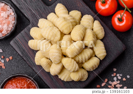 Raw homemade potato gnocchi, made with salt and spices, ready for lunch. Raw gnocchi Raw homemade potato gnocchi, made with salt and spices, ready for lunch. Raw gnocchi 139161103