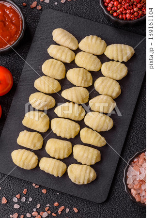 Raw homemade potato gnocchi, made with salt and spices, ready for lunch. Raw gnocchi Raw homemade potato gnocchi, made with salt and spices, ready for lunch. Raw gnocchi 139161104
