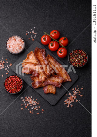 Fried fresh bacon slices with layers of meat or prosciutto prepared for breakfast. Fried bacon Fried fresh bacon slices with layers of meat or prosciutto prepared for breakfast. Fried bacon 139161111