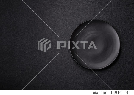 An empty ceramic round plate, kitchen utensils for a dinner table. An empty plate An empty ceramic round plate, kitchen utensils for a dinner table. An empty plate 139161143