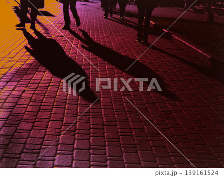 Abstract urban scene. Stylized high-contrast view of people's shadows on purple cobblestone, anonymity and movement of a crowd of people. Fine art. 139161524