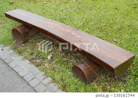 Wooden Bench on Green Grass at Park or Garden 139161744