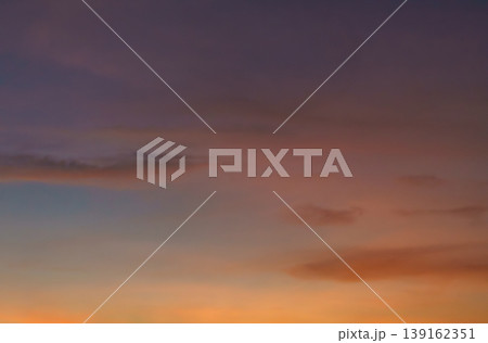 Colorful Sunset Sky with Gradient Clouds Over a Tranquil Horizon Colorful Sunset Sky with Gradient Clouds Over a Tranquil Horizon 139162351