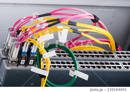 Fiber Optic cables connected to optic ports, network cables conn 139164041