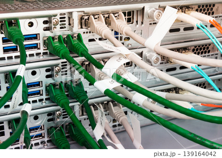 Fiber Optic cables connected to optic ports, network cables conn 139164042