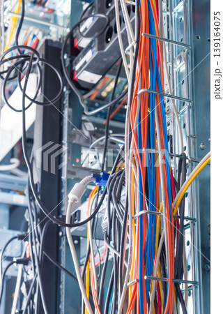 Detail of server room with bunch of fiber optic cables and ether Detail of server room with bunch of fiber optic cables and ether 139164075