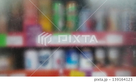 The store shelves appear blurry through the frosted glass backdrop. The store shelves appear blurry through the frosted glass backdrop. 139164123