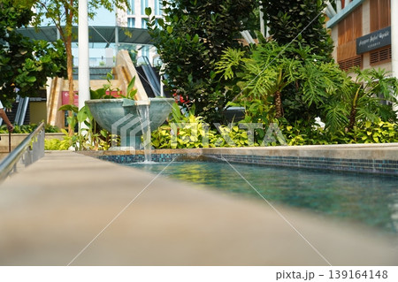 Urban Oasis Serene Fountain and Lush Greenery Landscape Urban Oasis Serene Fountain and Lush Greenery Landscape 139164148