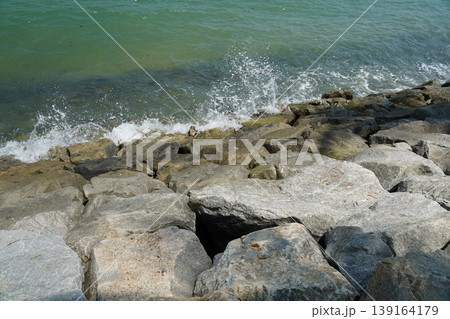 Waves Crashing on Rocky Shoreline Coastal Scene Waves Crashing on Rocky Shoreline Coastal Scene 139164179