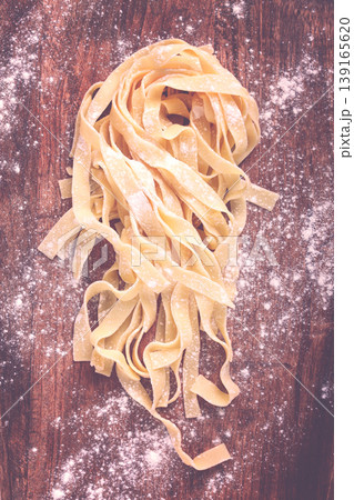 raw tagliatelli pasta , homemade, top view, no people, rustic, food concept, raw tagliatelli pasta , homemade, top view, no people, rustic, food concept, 139165620