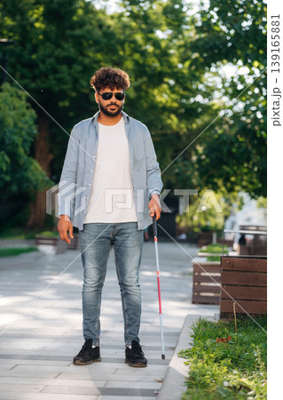 Using cane stick. Blind man in sunglasses is in the city Using cane stick. Blind man in sunglasses is in the city 139165881