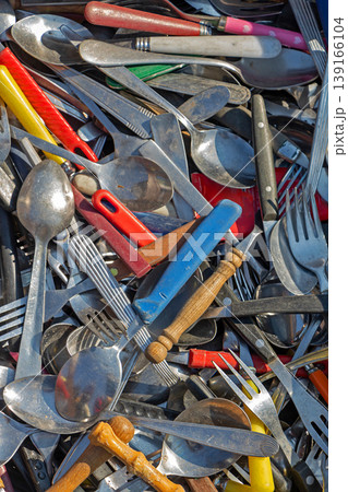 Silver metal and plastic cutlery pile Silver metal and plastic cutlery pile 139166104
