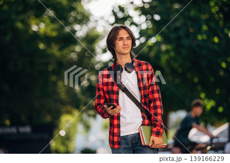 Feeling good, walking. Young student is outdoors at daytime 139166229