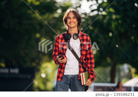 Happy young student is having a walk in the town 139166231