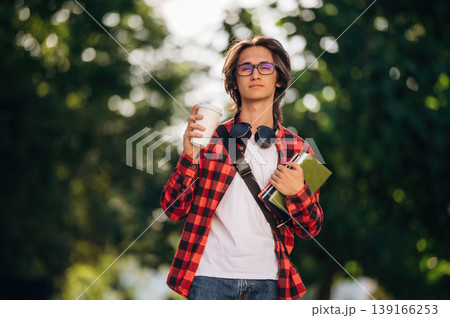 Smart, in glasses. Young student is having a walk in the town 139166253