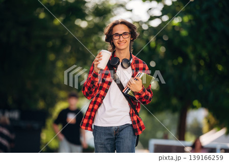 Having glasses on. Young student is having a walk in the town 139166259