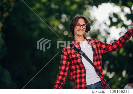 Young student is having a walk in the town 139166283