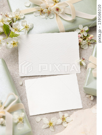 Double sided cards mockup with white spring flowers and driftwood on beige stone. Wedding invitation Double sided cards mockup with white spring flowers and driftwood on beige stone. Wedding invitation 139166310