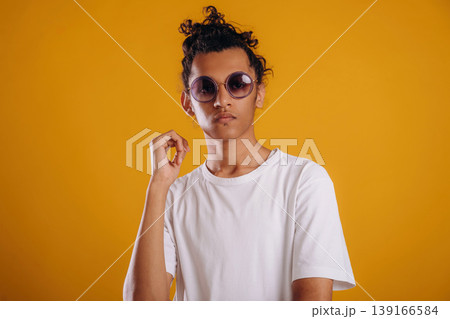 Young guy is against yellow background 139166584