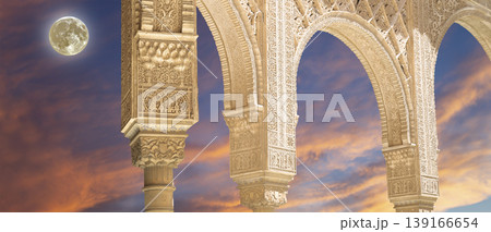 Arches in Islamic (Moorish) style (against the sunset with the super moon) in Alhambra, Granada, Spain 139166654