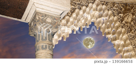 Arches in Islamic (Moorish) style (against the sunset with the super moon) in Alhambra, Granada, Spain Arches in Islamic (Moorish) style (against the sunset with the super moon) in Alhambra, Granada, Spain 139166658