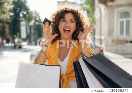 Ready to use the credit card. Happy woman is with shopping bags in town 139166875